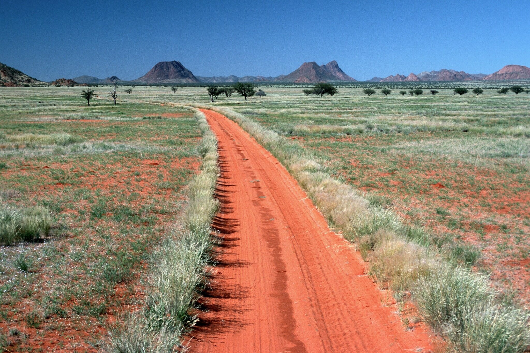 Red road crossing the Marienfluss Valley in Kaokoland, Namibia